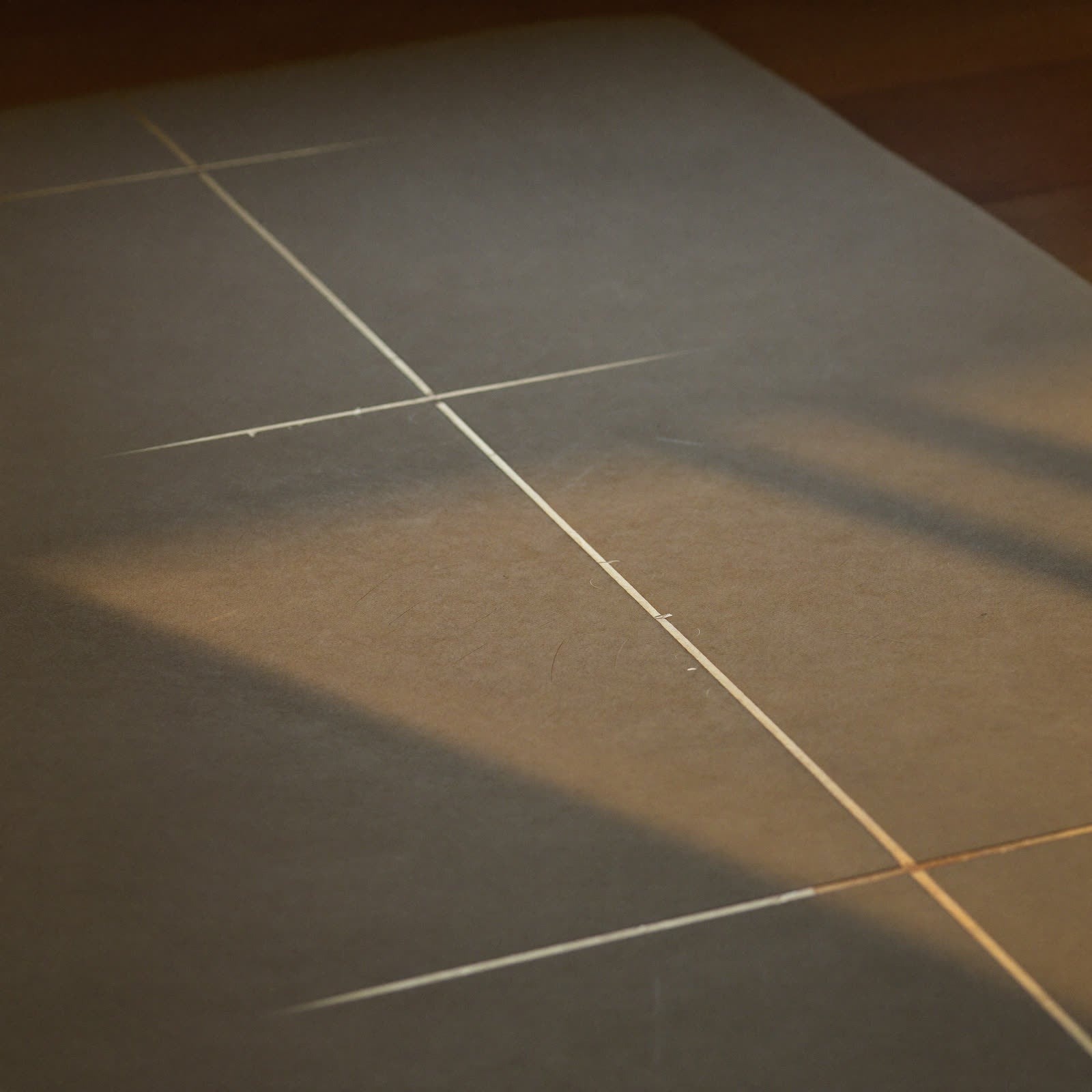 Close-up of hands holding the rolled texture of the Liforme Classic mat